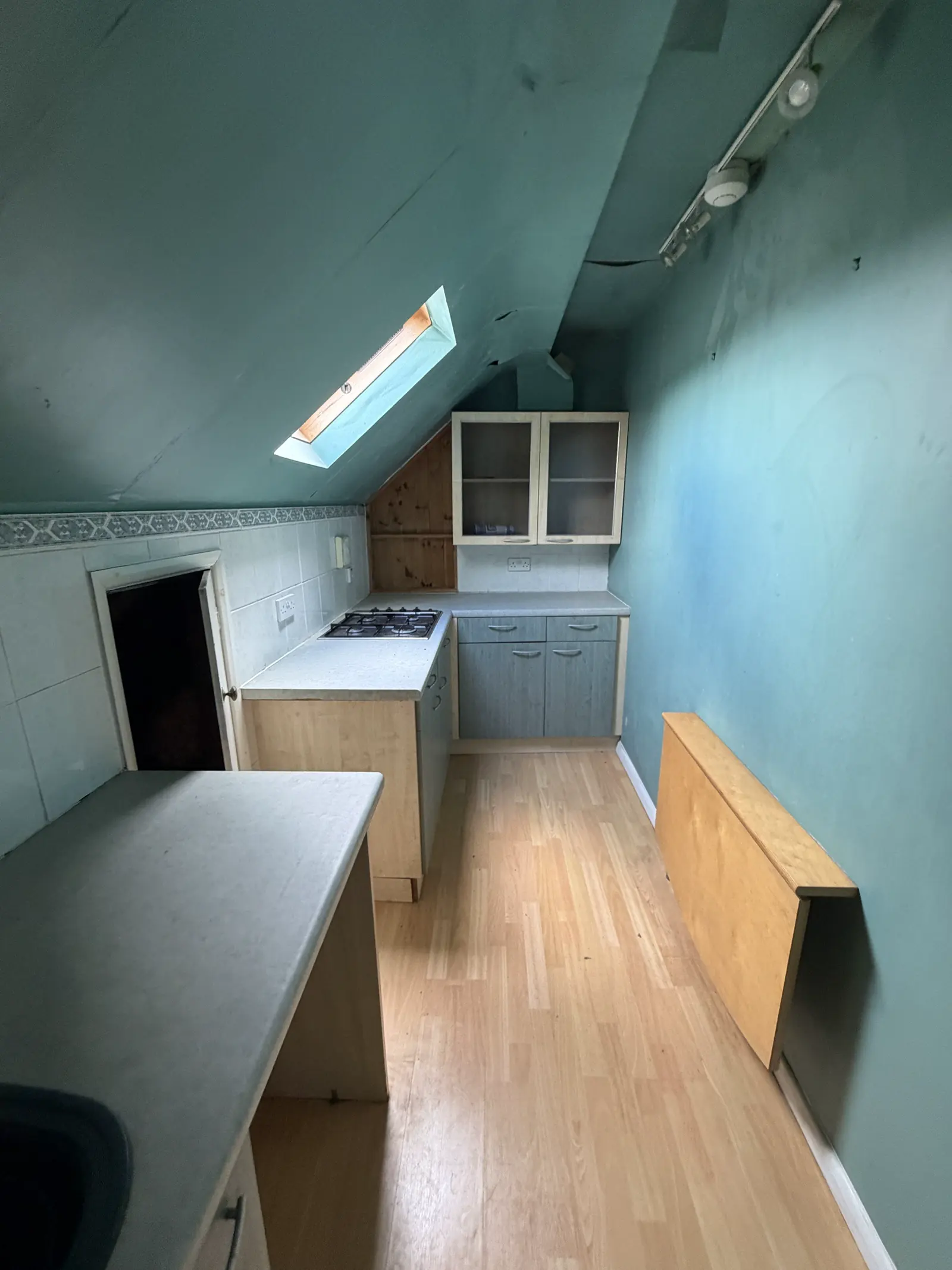 The second-floor kitchen today, under a sloping ceiling with a skylight